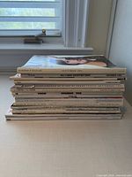 Stack of magazines on table, showing thickness and general condition