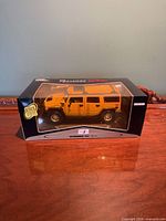 Front view of boxed yellow Hummer H2 model