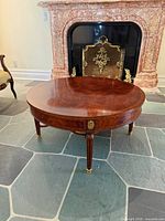 Top view of oval mahogany coffee table showing book-matched veneer and overall condition