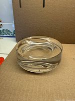 Angled side view of clear Rosenthal glass ashtray showing cylindrical form and interior groove