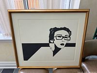 Front view of framed black and white portrait artwork in gilt frame
