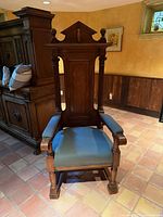 Front view showing full chair, crest, columns, upholstery