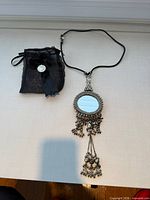 Necklace laid out with storage bag to show complete lot