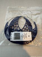Earrings in original plastic bag showing crochet pattern and price tag