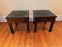Pair of black lacquer end tables side by side front view