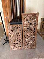 Front view of both carved panels showing overall design and wear