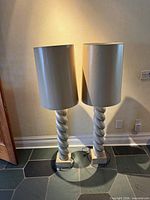 Front view of both floor lamps showing shades, columns, bases, cords