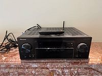 Front view of Pioneer VSX-935 receiver with remote on top