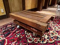 Angled view of wood factory cart showing top and casters
