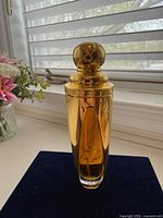 Front view of Cartier So Pretty EDP bottle on navy surface