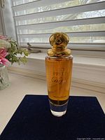 Front view of perfume bottle showing label and cap
