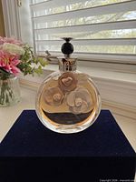 Front view of Valentino Valentina 80ml perfume bottle showing floral appliqués and liquid level