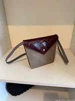 Front view showing textured body, quilted flap, snap, strap