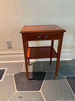 Front view of Remploy end table showing drawer, shelf, legs