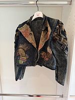Front view of acid-wash denim jacket showing heart patches and woven sleeve detail