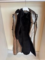 Front view of metallic faux fur vest on hanger