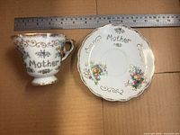Cup and saucer top view showing pattern, ruler for scale