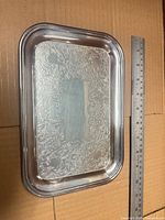 Top view showing ornate engraved border and overall size comparison with ruler