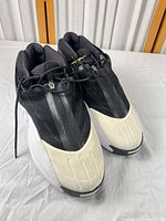 Pair of Adidas Crazy III Infinite shoes angled view showing uppers, toe guards, and zip shroud