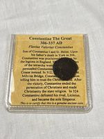 Front view of coin in clear folder with printed biography