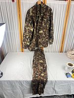 Full view of jacket hung and pants laid flat showing set