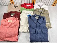Group shot of nine shirts laid out