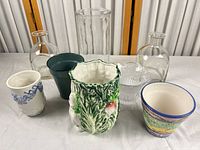 Group shot of all eight vases and planters