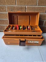 Closed tackle box opened displaying interior trays and compartments