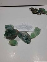 All six fluorite pieces with reference card visible