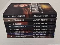 Stack of eight Kennedy Stern series novels showing spines with titles and volume numbers