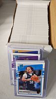 Box filled with stacked cards; front card Cole Anthony Rated Rookie in sleeve