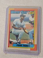 Front of 1990 Topps Frank Thomas rookie card in plastic holder