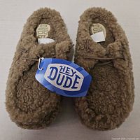 Top view of Hey Dude Wendy slippers with hangtag visible