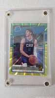 Front of LaMelo Ball holographic rookie card in screw-down case