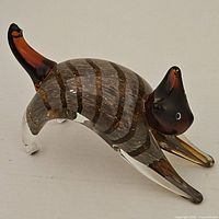 Full side view of striped Murano glass cat showing overall form and coloration