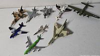 Group shot of all nine model airplanes arranged on surface