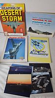 All four books and stack of aviation postcards overview