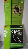 Boxed lighted spider and ghost decorations front view