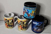 All four mugs together showing designs and colours