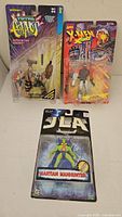Group shot of the three sealed action figures on their cards
