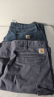 Rear view of both Carhartt jeans and cargo shorts showing logo patches
