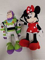 Front view showing Buzz Lightyear and Mickey Mouse plush backpacks