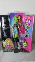 Front view of sealed Monster High Venus McFlytrap doll package showing doll and accessories