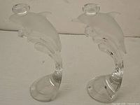 Front view of both crystal dolphin candlesticks
