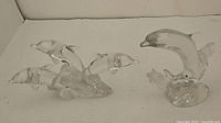 Both Lenox crystal dolphin figurines side by side