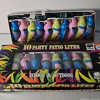 Two boxed parrot string light sets, front view showing product name and window