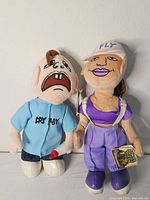 Front view of both plush dolls standing