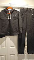 full view of jumper and trousers hanging