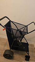 Full view of folding beach cart showing mesh basket and handle
