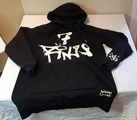 Full view of black Ariana Grande 7 Rings hoodie front
